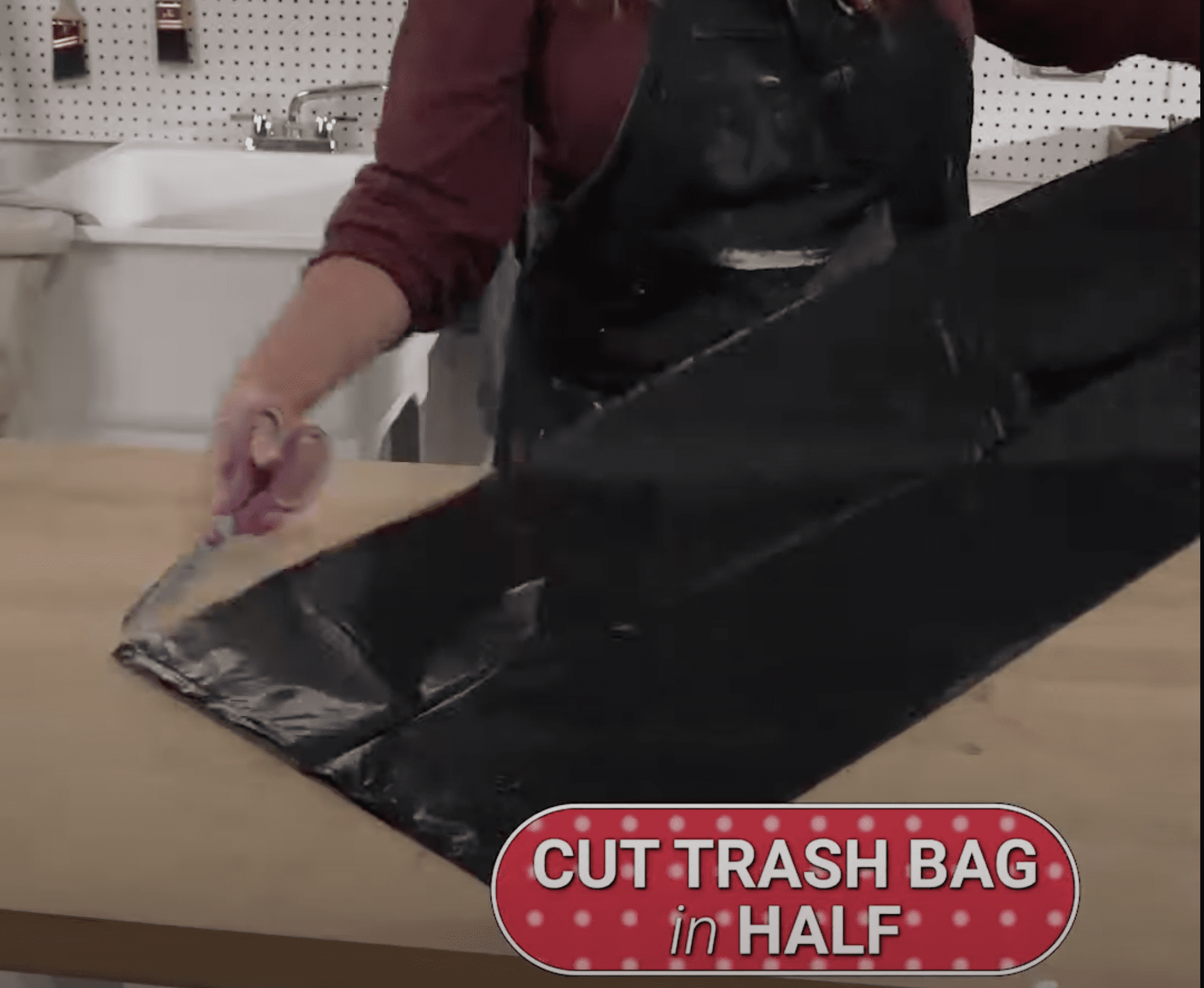 Scissors cutting trash bag in half